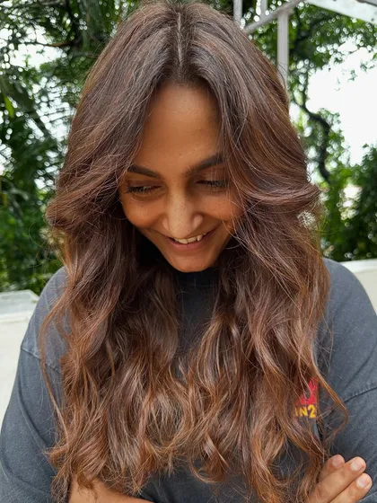 Getting her ready for a work trip with a professional yet stylish look. These 'Almond Brown' tresses are chic and sophisticated, with just enough color to feel fresh and confident.