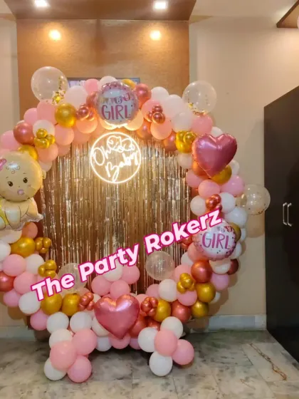 The full view of the pink and gold welcome baby balloon ring, complete with "It's a Girl" and baby-shaped foil balloons.