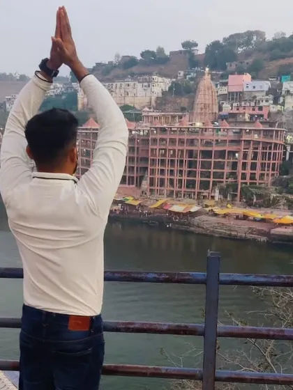 Paying respects at the Omkareshwar temple. Combining physical postures with devotion, or Bhakti Yoga, is a powerful way to connect the body, mind, and spirit.