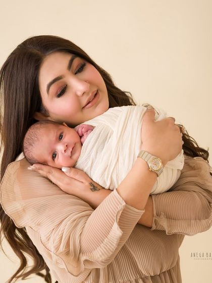 A mother's gentle embrace. This close-up shot captures the profound bond and overwhelming love between a mother and her newborn.