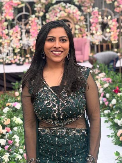 A happy moment captured before an event, with a beautiful floral backdrop. My goal is to be a warm and approachable presence for you and your guests.
