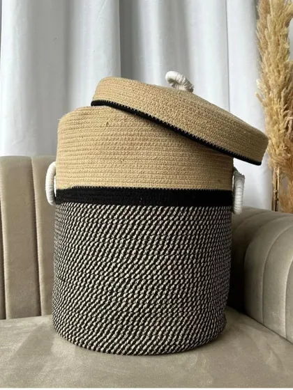 For a more minimalist and modern aesthetic, I have this two-toned black and beige laundry basket. It's large, stylish, and comes with a lid.