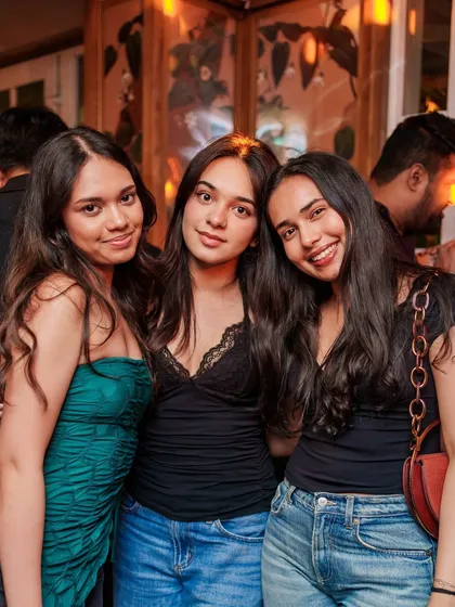 A group of friends posing for a photo, making memories at VIBE CHECK.