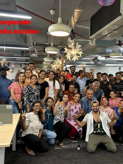 The smiles say it all. A post-session group photo capturing the happy and energized employees after a fun corporate Zumba workout in their office. This is what effective team building looks like.