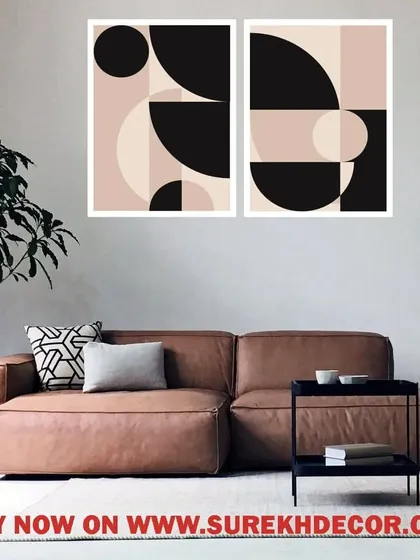 A minimalist set of two framed prints featuring abstract geometric shapes in a soft, neutral palette. This artwork adds a touch of modern sophistication to a contemporary living space or bedroom.