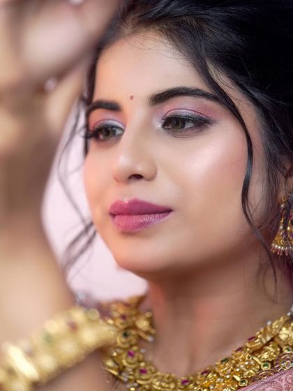 The perfect bridal glow, enhanced by our antique gold choker and jhumkas. This close-up shows how our jewellery frames the face and complements bridal makeup.