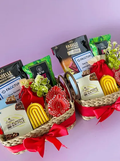 An angled view of two Kauna basket hampers, showcasing the variety of Fabelle chocolates and other treats I can include.
