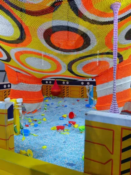 Even our littlest visitors have a world of their own to explore. This is a peek into our dedicated toddler area, filled with soft, sensory-rich toys in a safe and enclosed ball pit.