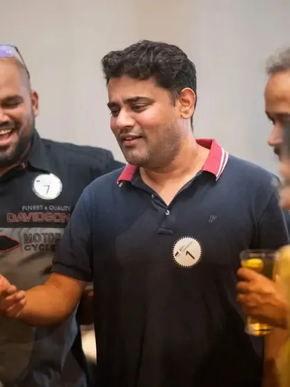 Two guests sharing a laugh during a close-up interaction. Magic is a fantastic way to bring people together and create shared experiences.