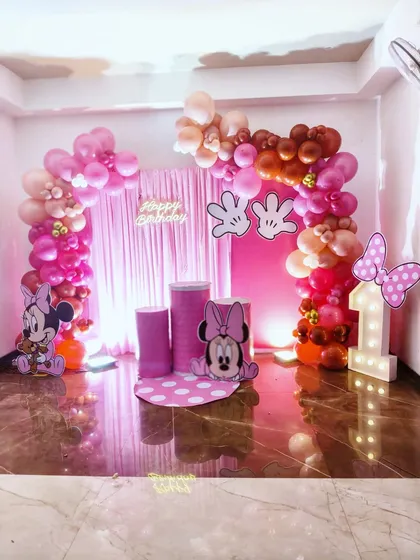 You can't go wrong with a classic. This Minnie Mouse first birthday party is one of my popular requests, complete with character cutouts, a themed balloon arch, and a light-up marquee number '1'.