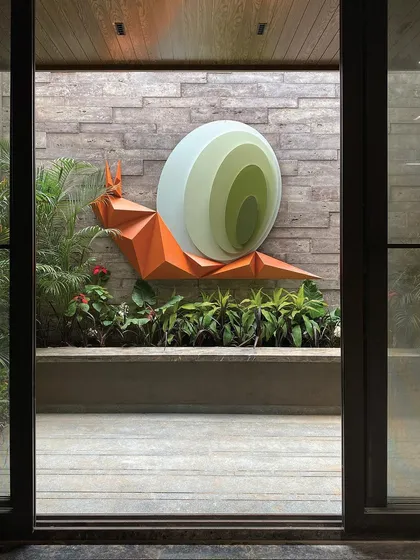 Art is a key element in my biophilic design approach. This captivating snail art installation, titled "Harmony in Motion," is nestled within a landscaped court, designed to evoke a sense of wonder and create a feeling of symbiosis between the sculpture and its natural surroundings.