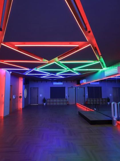 Our main studio hall with dynamic, multi-color lighting. This versatile space can be transformed to match the vibe of any performance, from sangeet rehearsals to professional video shoots.