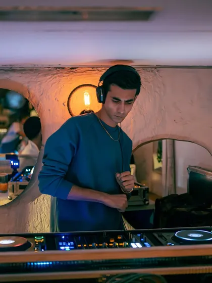 A quiet moment of focus before dropping the next beat. Every track in a throwback set is chosen with care.