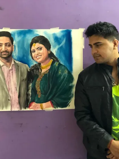 A custom oil portrait of a couple for a client in Telangana. I'm standing next to the finished piece.