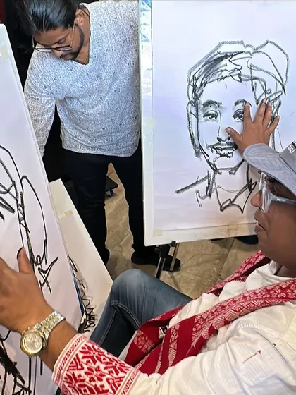 A live demonstration at the Kalaspandan Art Fair in Pune, where I am working on three charcoal portraits simultaneously.