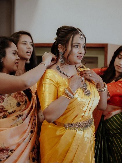 The bride's squad helping her get ready, a beautiful moment of friendship and support on her engagement day.
