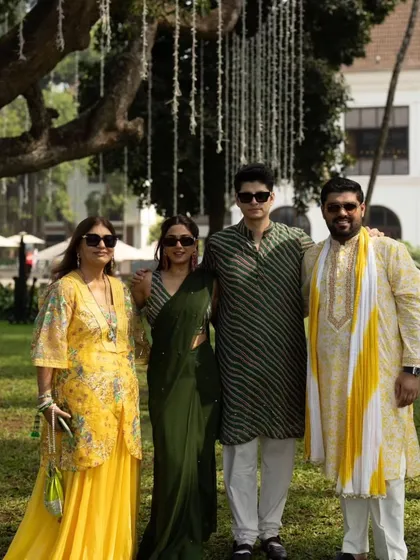 A group photo from the Haldi ceremony, with guests dressed in shades of yellow and green, perfectly complementing the festive theme.