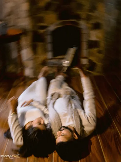 A dizzying rush of emotion. This motion blur shot captures the feeling of being swept up in a moment, a whirlwind of love and connection by the fireplace.