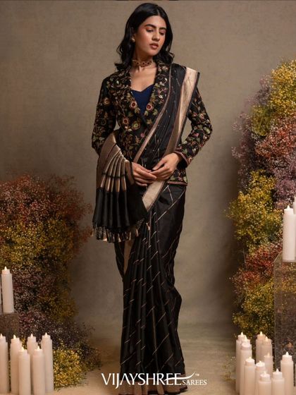 The full look of the black Banarasi saree with the jacket, a perfect fusion of traditional fabric and contemporary styling.