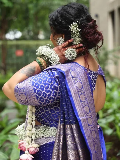 This angle highlights the floral bajuband (armlet) and hair accessories, showing how the full set comes together to create a complete, traditional look.