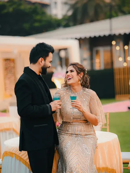 Capturing genuine laughter and joy. This photo of the couple sharing a lighthearted moment at their reception is full of happiness.