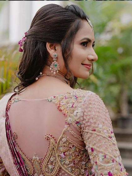 The back of the bride's blouse reveals an intricate, sheer design with delicate embroidery. It's a perfect example of how I focus on 360 degree beauty in my designs.