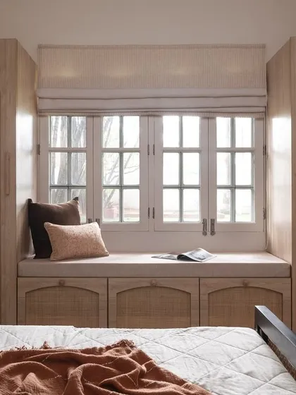 This bedroom showcases my love for natural textures and smart storage solutions. I used rattan on the arched wardrobe doors and under-window cabinets to bring warmth and timeless elegance, creating a bright and airy retreat that feels both classic and contemporary.