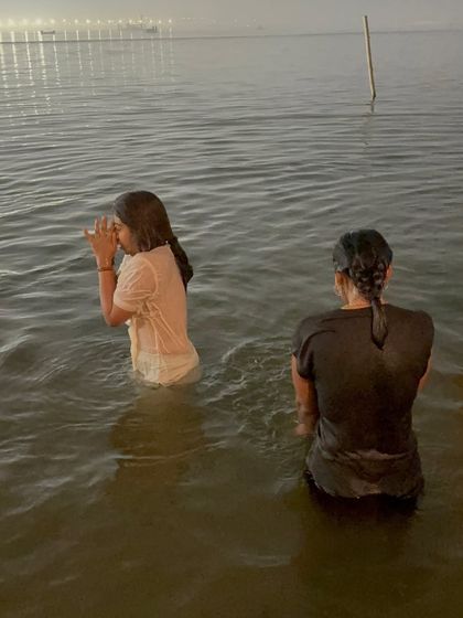 Taking a holy dip in the Sangam at the Mahakumbh. This act of purification is a central ritual, believed to wash away karmas and bring one closer to liberation.