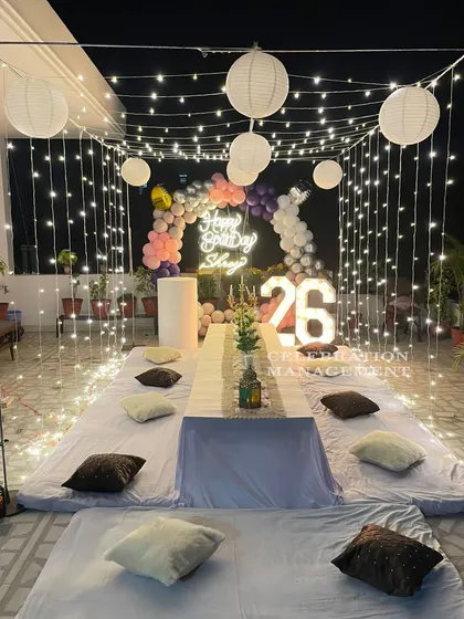 Another take on an enchanting terrace party, this time for a 26th birthday. I built a cube of fairy lights, hung paper lanterns for a soft glow, and arranged floor seating around a central table, complete with marquee numbers to mark the special age.