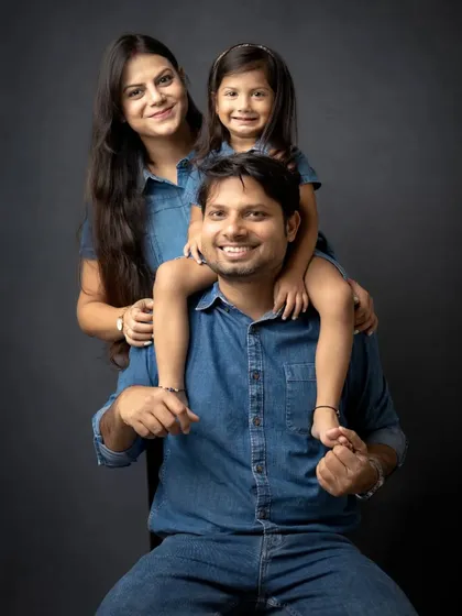 A fun family pose with the daughter on her father's shoulders. This classic "piggyback" shot always brings out the biggest smiles.