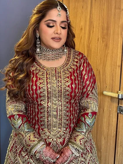 A glamorous reception look featuring deep waves and a side part, perfect for framing the face and showing off statement jewelry.