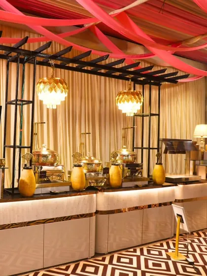 Another view of our elegant white and gold buffet counters, this time featuring a live kebab station. The setup is both functional and aesthetically pleasing, fitting for a royal occasion.