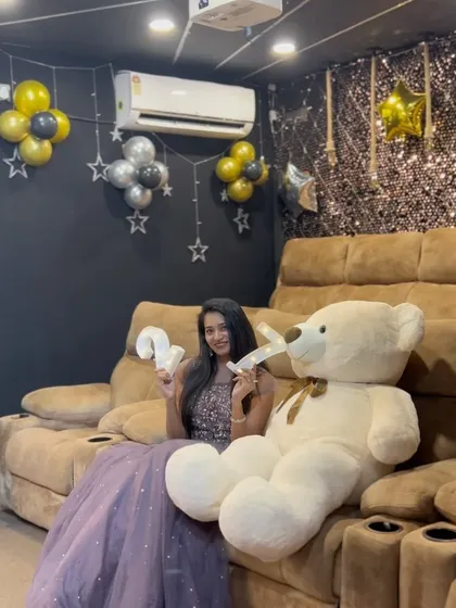 Celebrating 27 in style. This birthday girl looks stunning in her gown, posing with a giant teddy bear in one of my theaters. It's a perfect example of how you can have a glamorous photoshoot during your celebration.