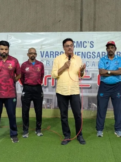 Standing with my team of experienced coaches as we address the young players. A united coaching front is crucial for player development.