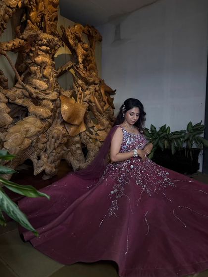 A full-length shot of this magnificent wine-colored gown. The intricate embroidery and full skirt make it a truly show-stopping piece.