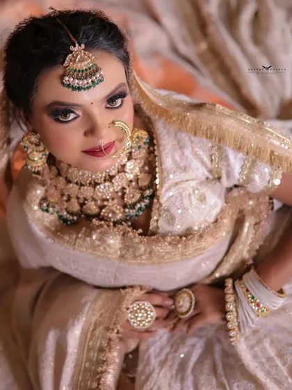 An artistic top-down shot, focusing on the bride's expression and the large, statement rings.