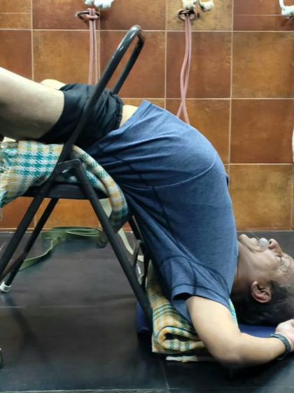 A supported backbend over a chair.