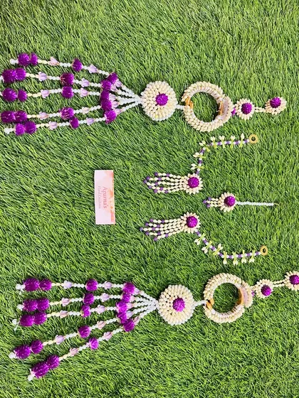 A matching set of floral jewellery for a Mehendi ceremony, including two sets of haath phool for the bride and a friend or sister.