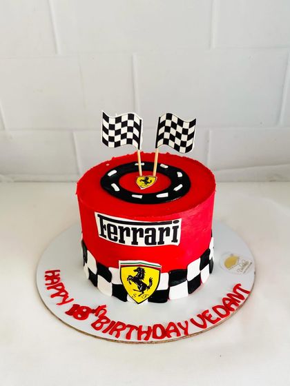 A simple yet striking Ferrari cake with a checkered pattern and logo.