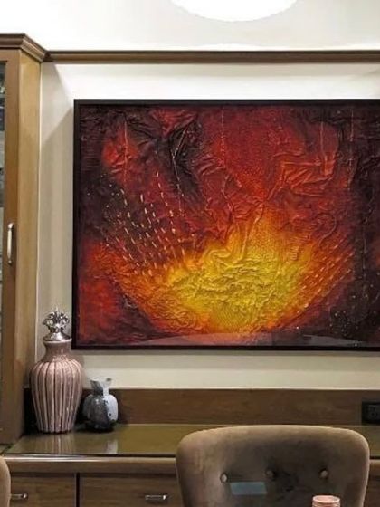 Here is one of my textured abstract pieces, "The Rising Sun," installed in a client's dining area. The vibrant reds and yellows bring warmth and energy to the space.