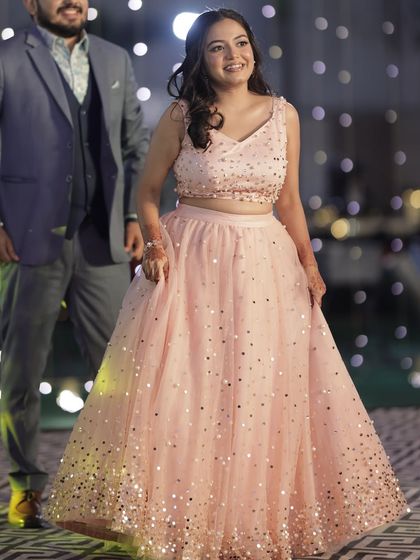 A full-length shot of this pretty pink cocktail outfit. The soft, dewy makeup complements the sparkly dress without being overpowering.