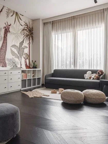 We designed the nursery to be a playful yet calming space. A jungle-themed wallpaper adds a touch of whimsy, while the furniture is functional, comfortable, and provides ample storage.