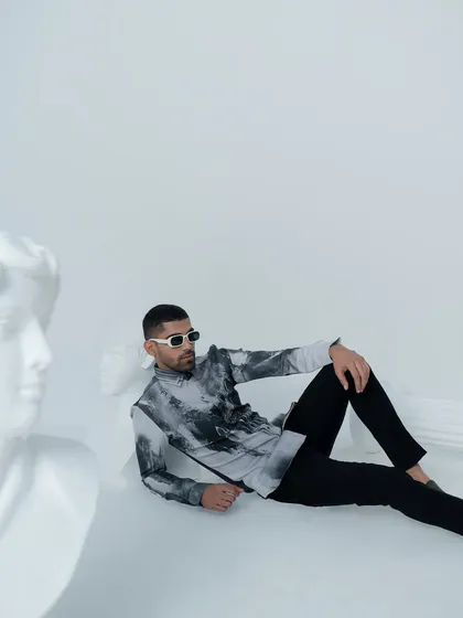 This 'Greek Reverie' look features a printed shirt with a marble like texture. It's a modern, artistic piece that is perfect for a stylish evening out.