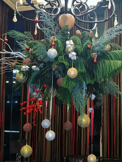 To bring festive magic to a room, I designed this Christmas chandelier installation. I used fresh pine, ilex berries, and shimmering ornaments to create a cascading display that feels both elegant and full of holiday cheer.