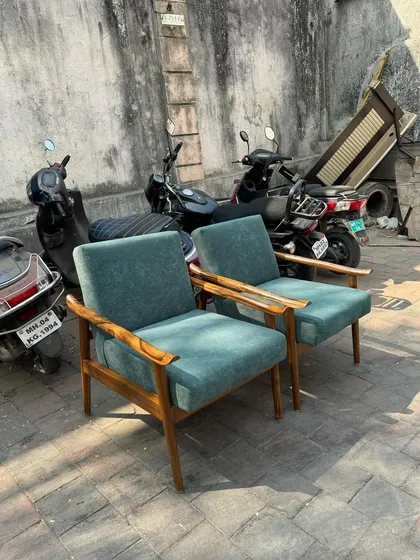 A sunny shot of the pair of teal lounge chairs.