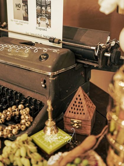 A close-up of the vintage typewriter with a sheet telling the couple's story through photos.