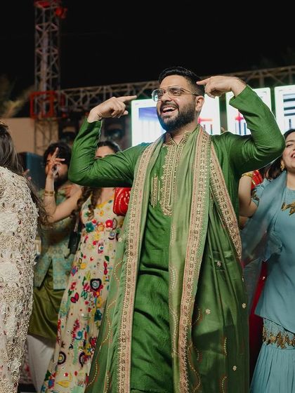 Candid shots are the best! The groom enjoying himself on the dance floor with his family.