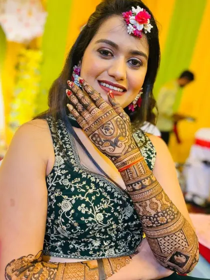 A happy bride showing off her intricate mehndi. The deep, rich stain is the result of my 100% natural and organic henna paste, which I guarantee for every bride.