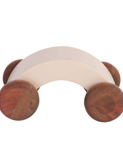 A front-on view of a white wooden arch-shaped toy car.