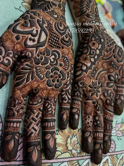 A full view of the 'Ayat' design, with both hands covered in beautiful, dense patterns.